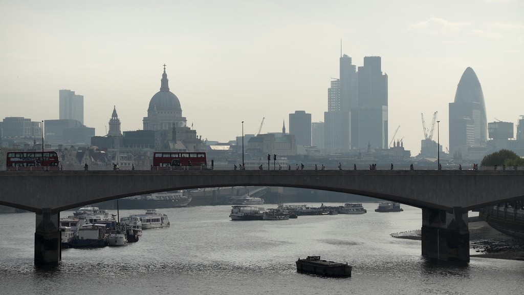 The Waterloo bridge over the Thames in London, with the Londone skyline behind it.