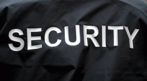 A black jacket with the word security on the back of it.