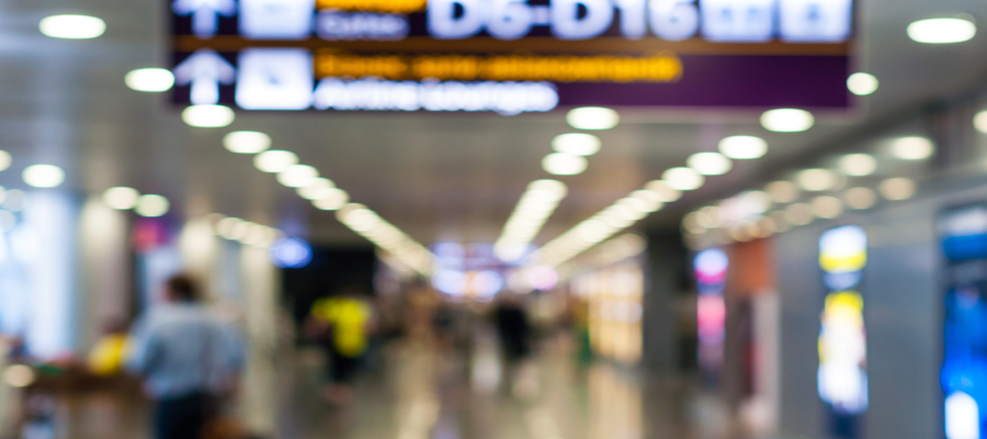 Very blurry photograph of people in an airport terminal.