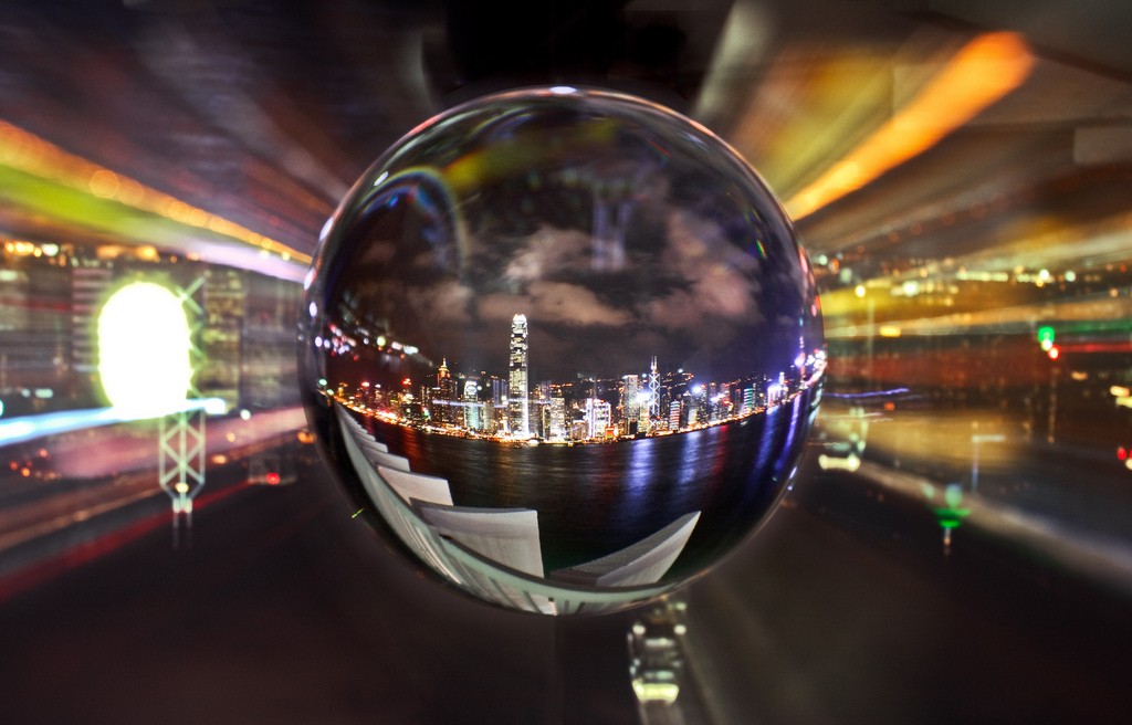 Crystal ball reflecting a downtown city at night.