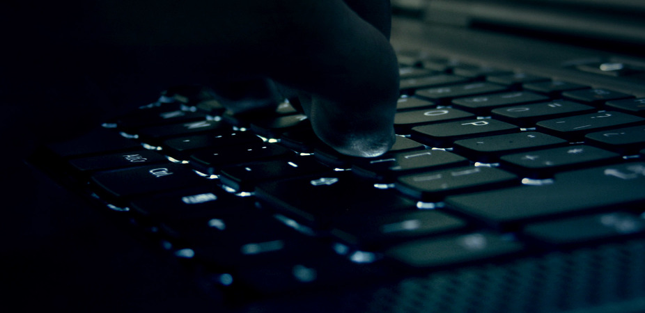 A closeup of fingers on a keyboard.