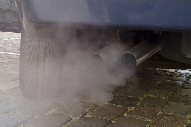 Exhaust pouring out of the exhaust pipes of a truck.