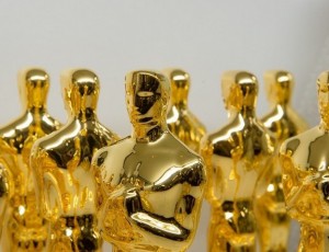 Several Oscar award statues in a group.