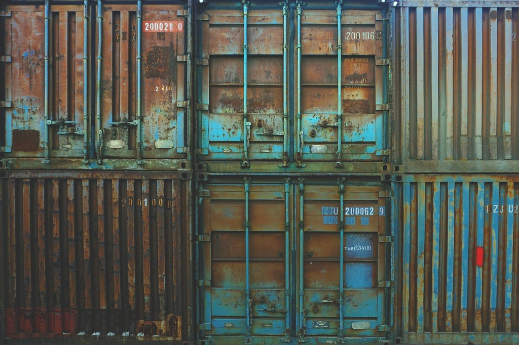 6 very large shipping containers, 3 stacked on 3.