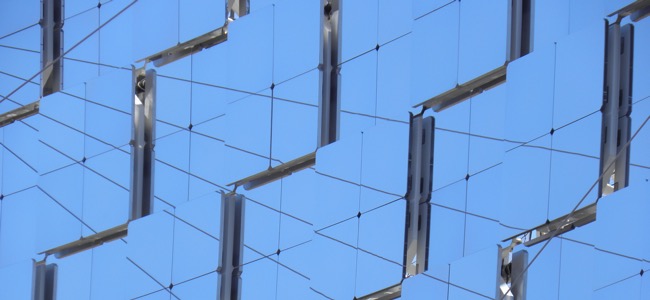 The side of a building covered in mirrors.