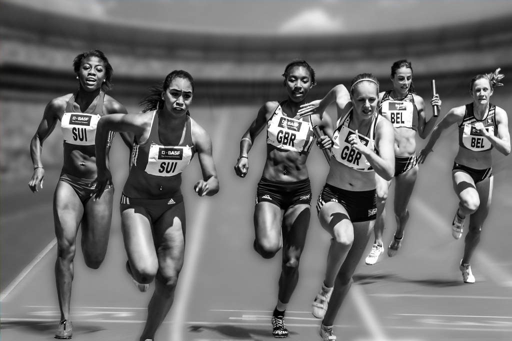 Women running a relay race.