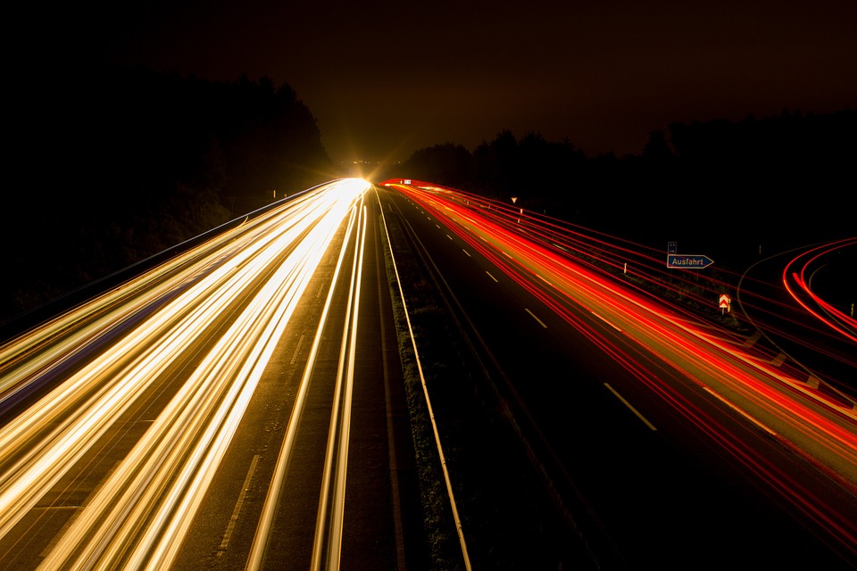 A time lapse of cars on a highway so it looks like streaks of light.