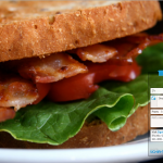 A closeup of a Bacon Lettuce and Tomato sandwich with a Media Shuttle email form superimposed over it.