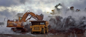 Large machinery loading waste rocks into a dump truck in the Jellinbah Central Mine in Australia.