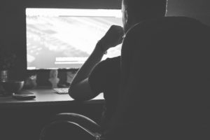 A man working on his computer late at night.