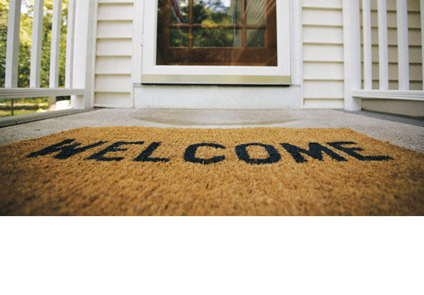 A welcome mat on a front porch.