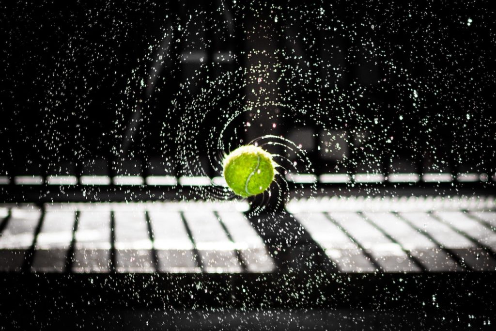 A wet tennis ball spinning through the air.