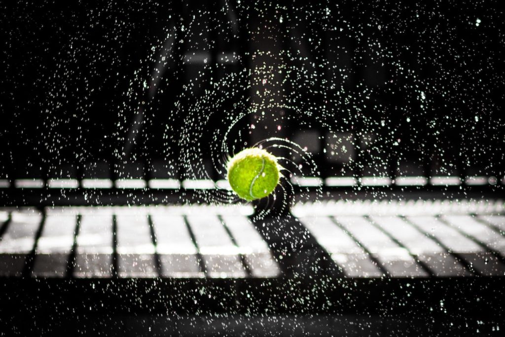 A wet tennis ball spinning through the air.