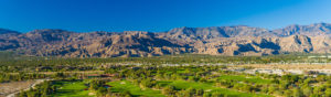 Palm Desert with brown mountains in the background.