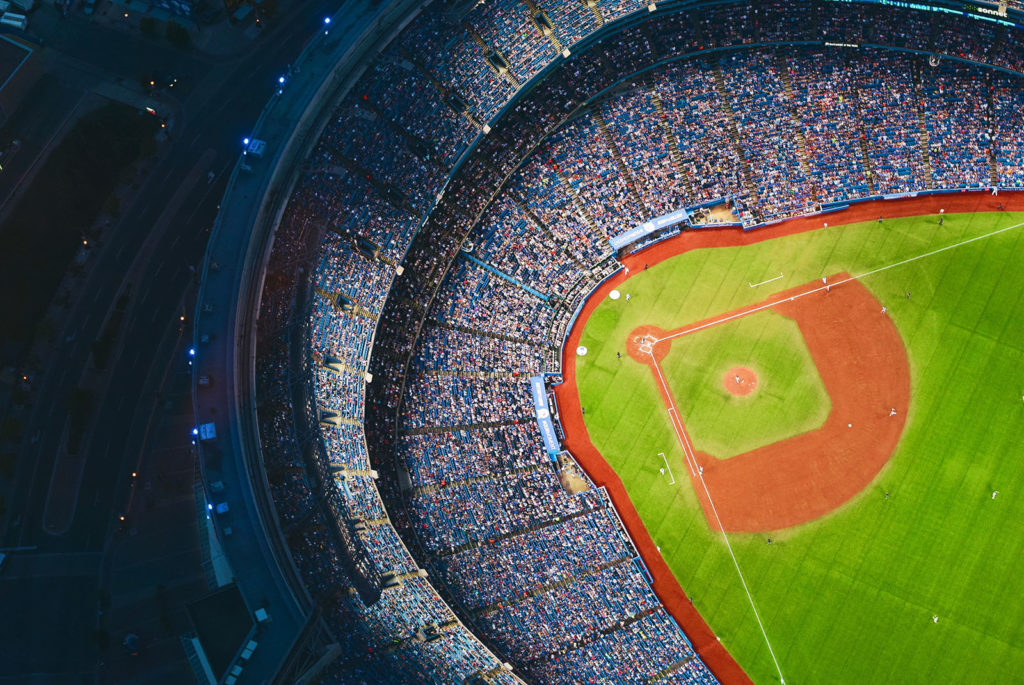 The world series being played in a large stadium next to a highway.