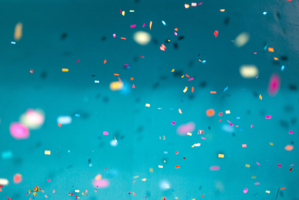Confetti on a teal background.