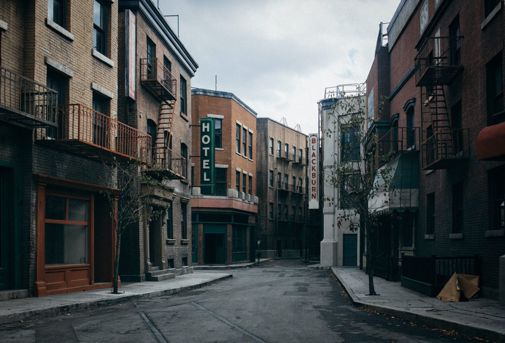 An empty street in Burbank, California, with apartment buildings, a hotel and other stores.