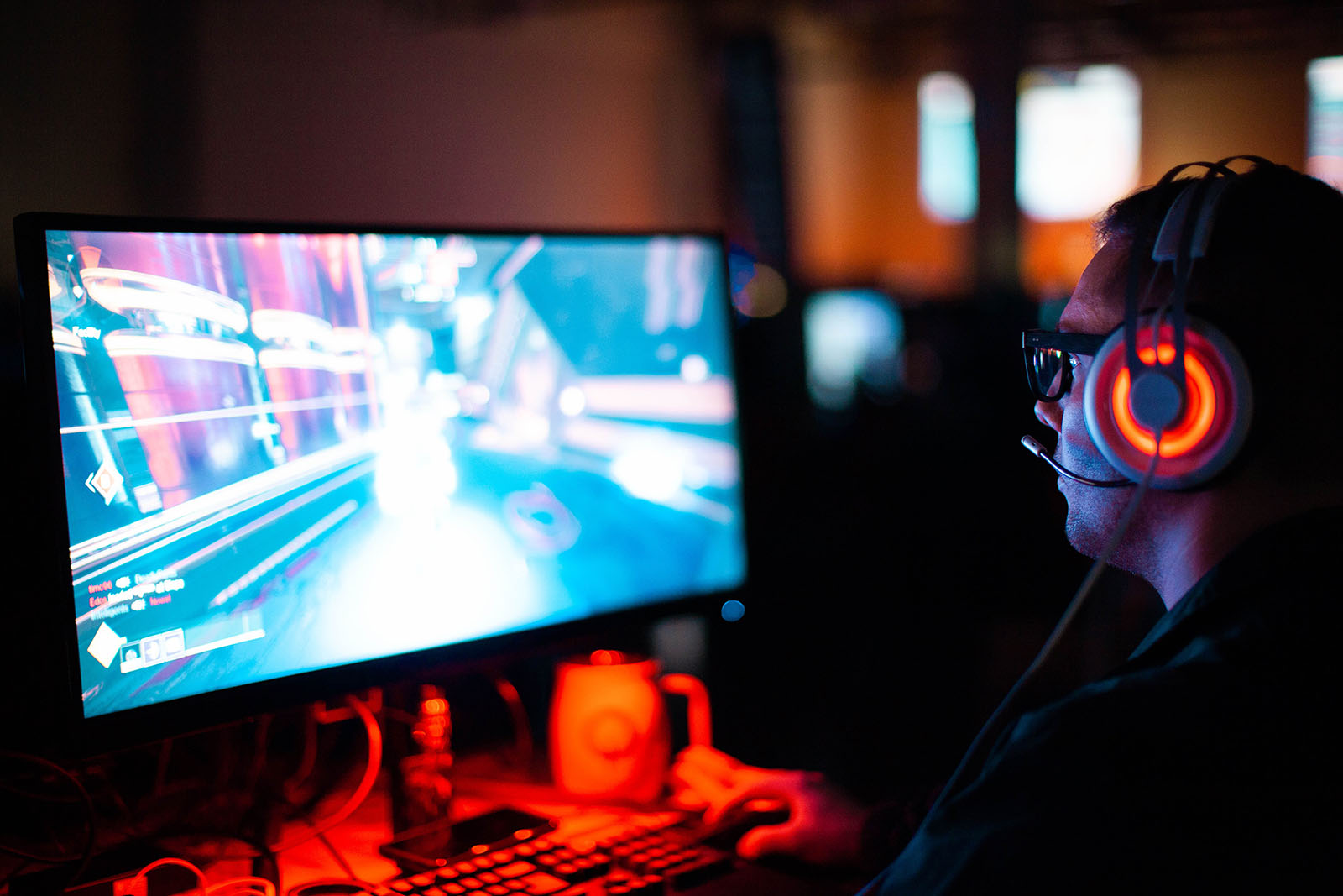 A man playing a video game in the dark.