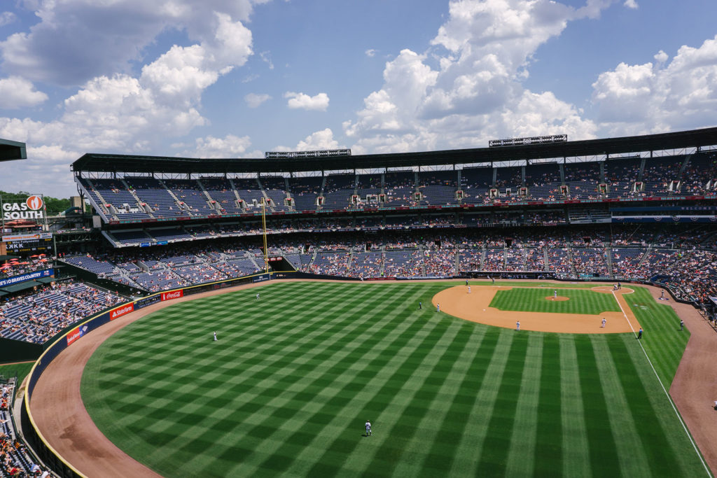 A baseball field in a large stadium.