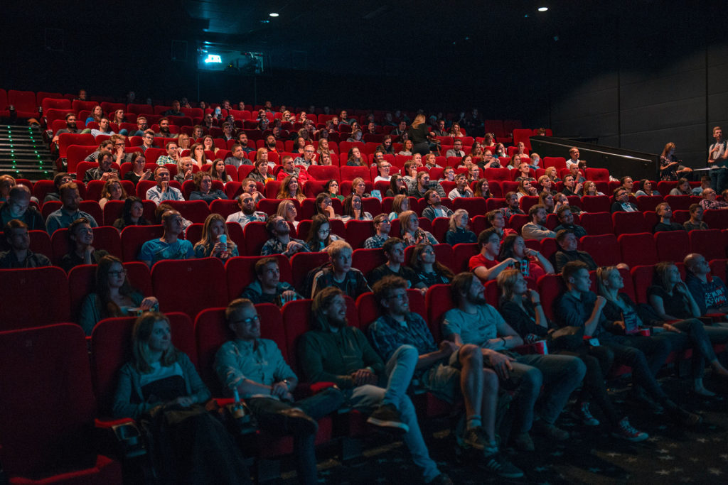 A full audience in a movie theatre.