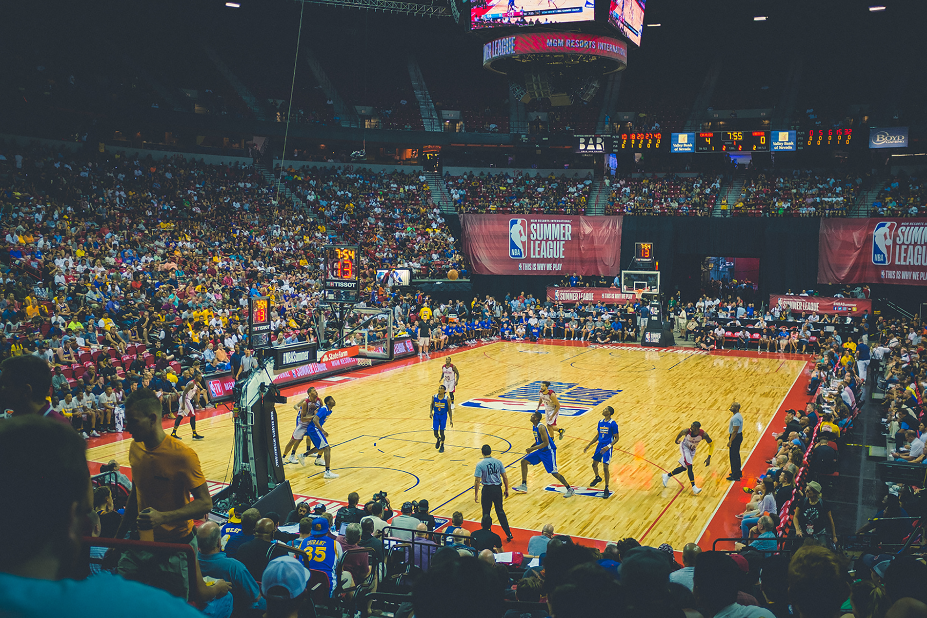 An NBA basketball game in a packed stadium.