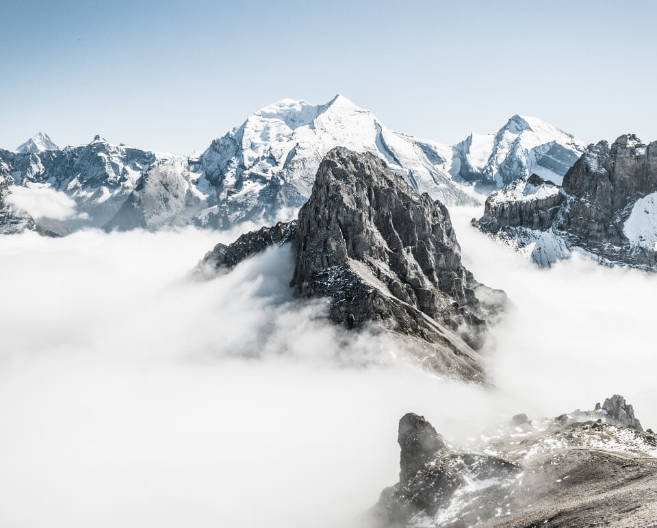 Mountain peaks with clouds around them.