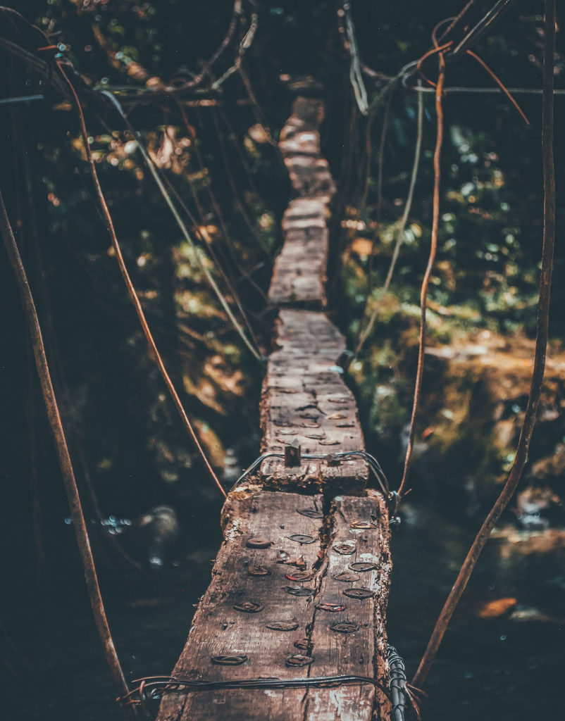 A very narrow and rickety foot bridge.