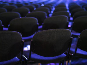 A room full of black chairs.